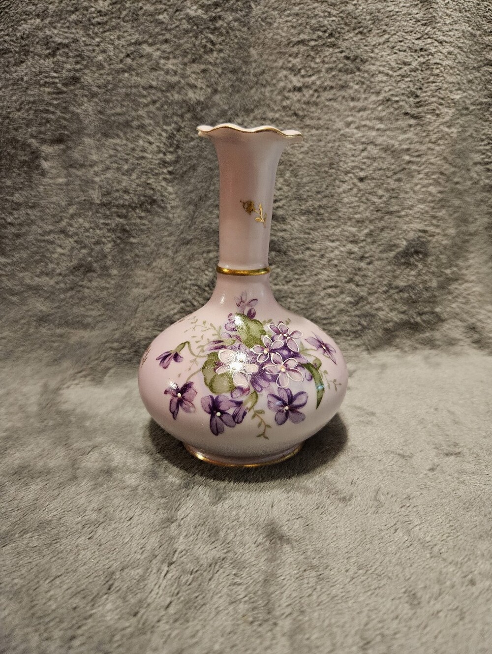 Lavender bud vase. 5" tall. Chip, as seen in picture, on the top of vase.